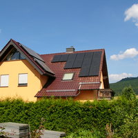 gelbes Haus mit Solaranlage